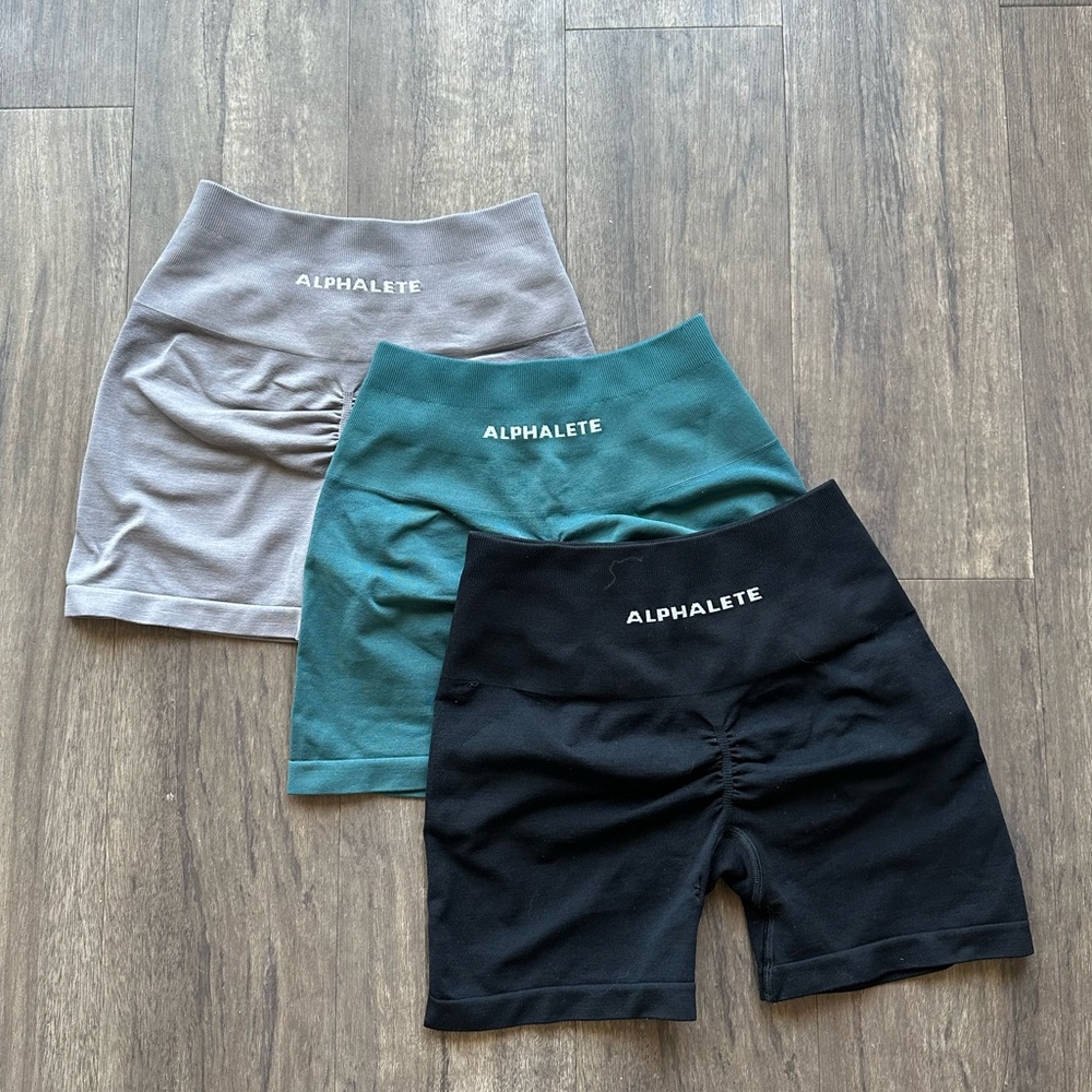 Alphalete Amplify Short 4.5” Three Pack 
- Black, Gray, Teal